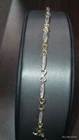  LADIES TENNIS BRACELET. TWO-TONE10KT.50CT. 5.80 G